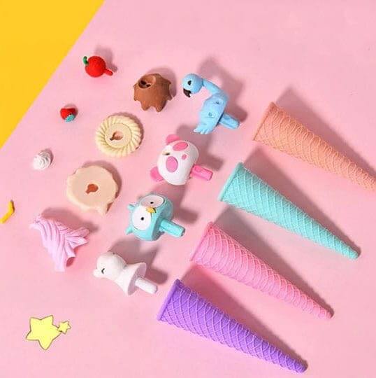 Assorted set of four whimsical ice cream cone erasers, including an owl, blue swan, pink unicorn, and strawberry-topped bear, displayed in a retail box by Usmile Toys.